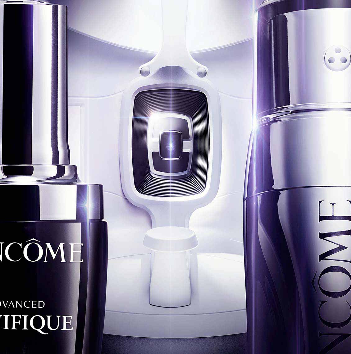 Close-up of Lancôme Advanced Génifique and Rénergie H.C.F. Triple Anti-Ageing Serum bottles with a futuristic skincare device in the background, highlighting advanced skincare technology